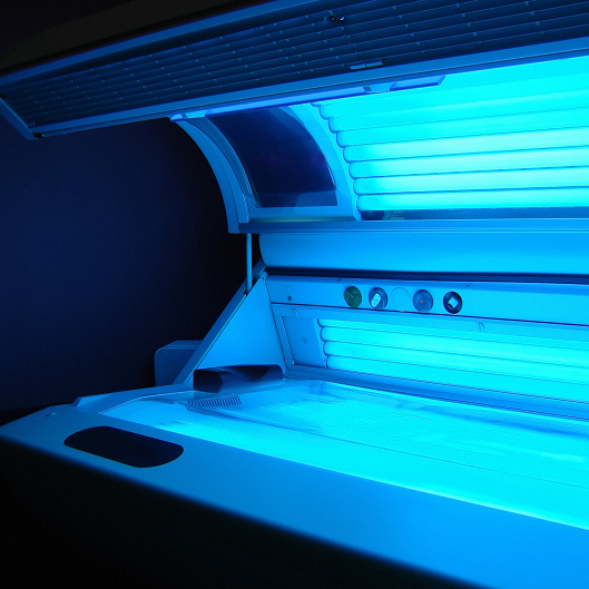 tanning bed ajar with the lights on