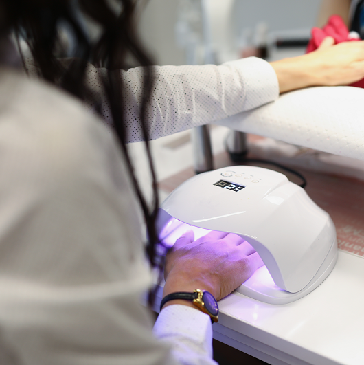 Woman getting her nails done with a gel manicure