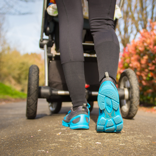 New mom walking with her baby in a stroller