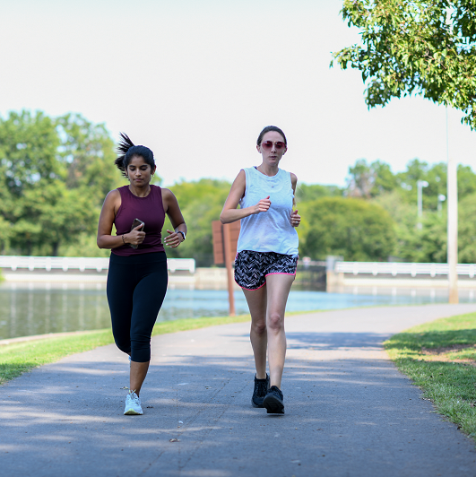 Two young women jogging in the park together