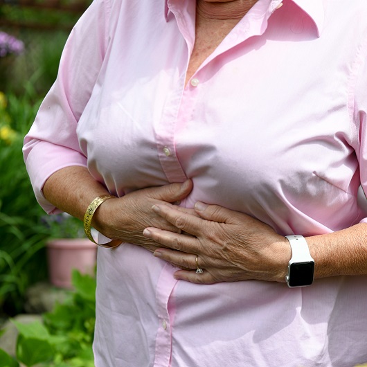 Woman clutching her stomach from pain