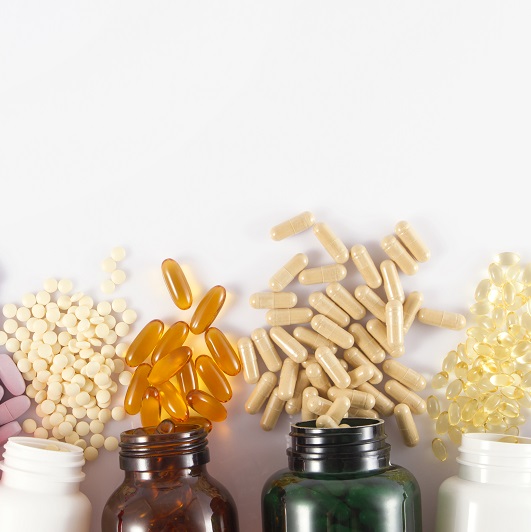Close-up shot of medicine pills and liquid capsules for migraine.