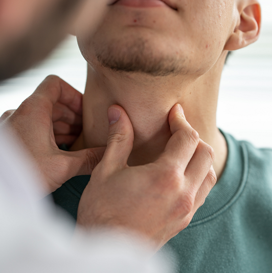 Doctor examining patient's throat and thyroid