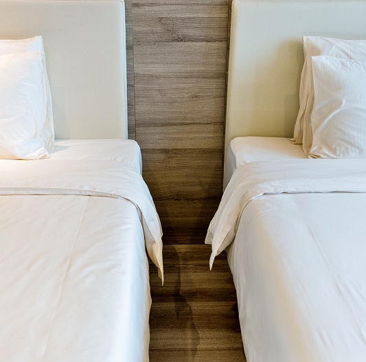 Sleep divorce concept - two beds next to each other.