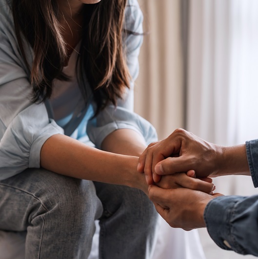Close up of partners holding hands and supporting each other.