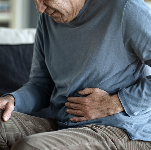 Older man with stomach pain from constipation.