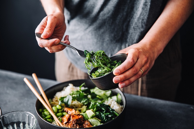 Close up shot of a person preparing a healthy salad.