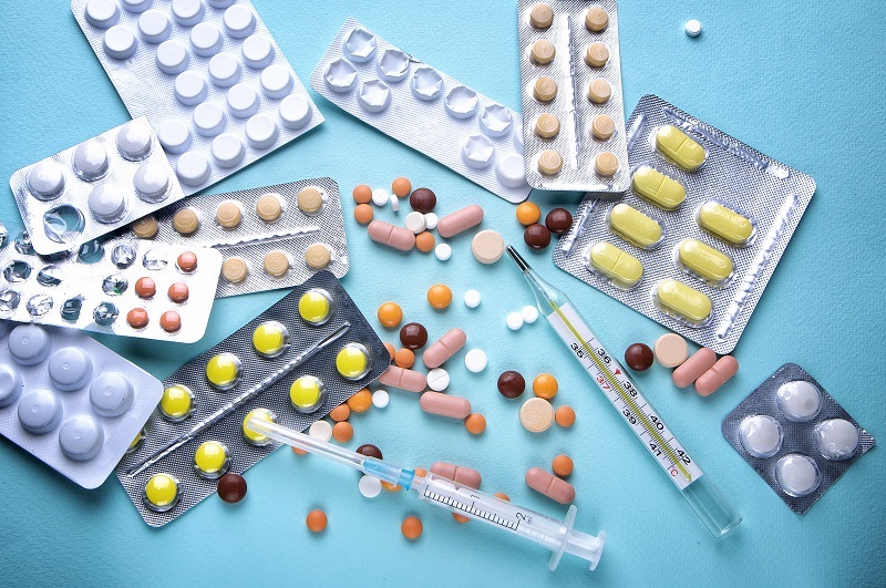 Medicine pills in packs and syringes.