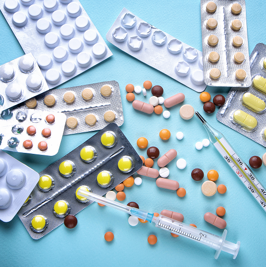 Medicine pills in packs and syringes.