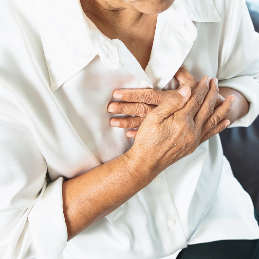 Woman holding her chest with difficulty breathing.