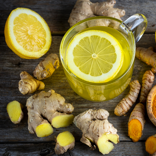 Ginger, lemons and tea on a tabletop. 