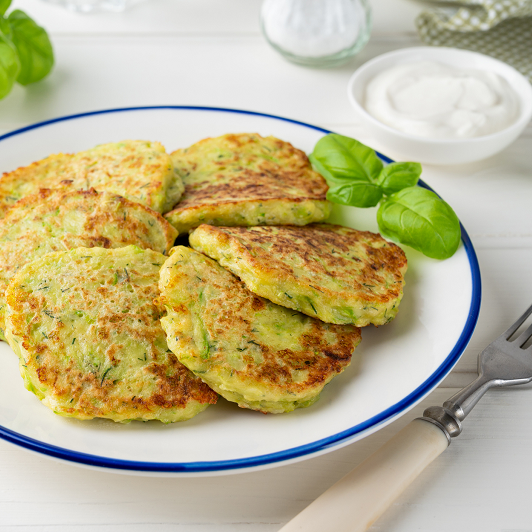 Zucchini fritters paired with creamy labneh.