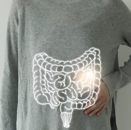 Woman in a gray sweater with a highlighted vector visualization of a colon.
