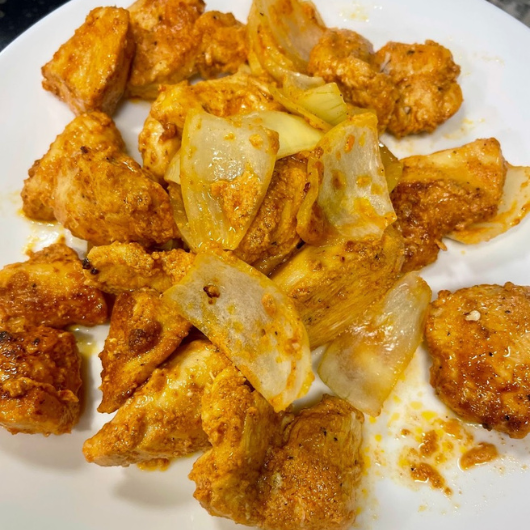 A plate of freshly-cooked, seasoned shish tawook (chicken skewers.)