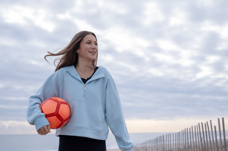Kelly Griffin, a soccer player at Albright College in Reading, Pennsylvania, holds a soccer ball while smiling.