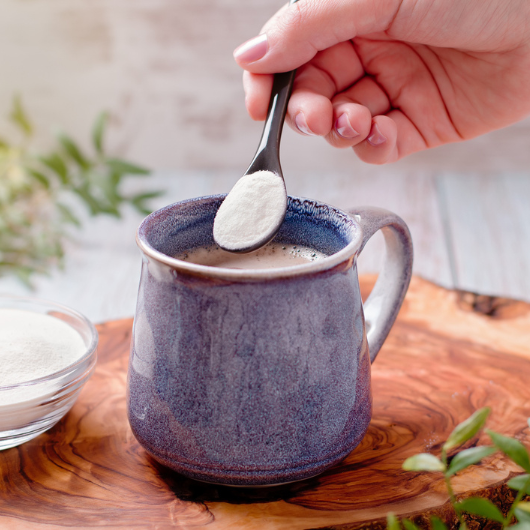 Coffee and collagen powder on a wooden board.