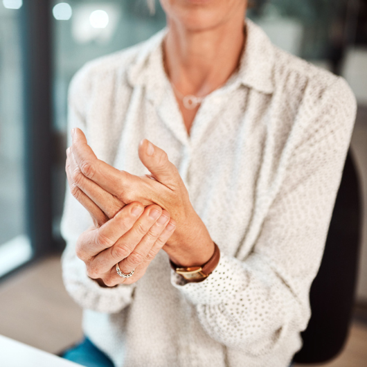 Closeup shot of an unrecognizable businesswoman experiencing discomfort in her hand while working in an office.