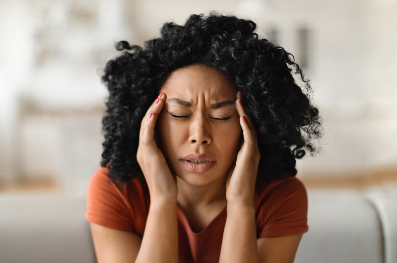 Woman dealing with migraine head pain