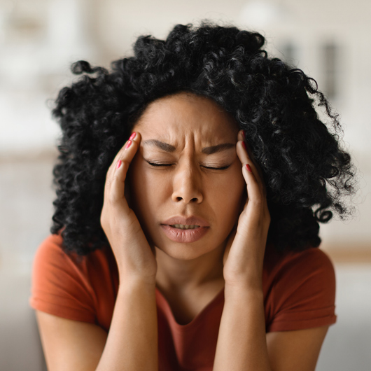 Woman dealing with migraine head pain