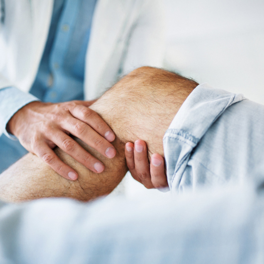 Image of patient with arthritis consulting with a physician.