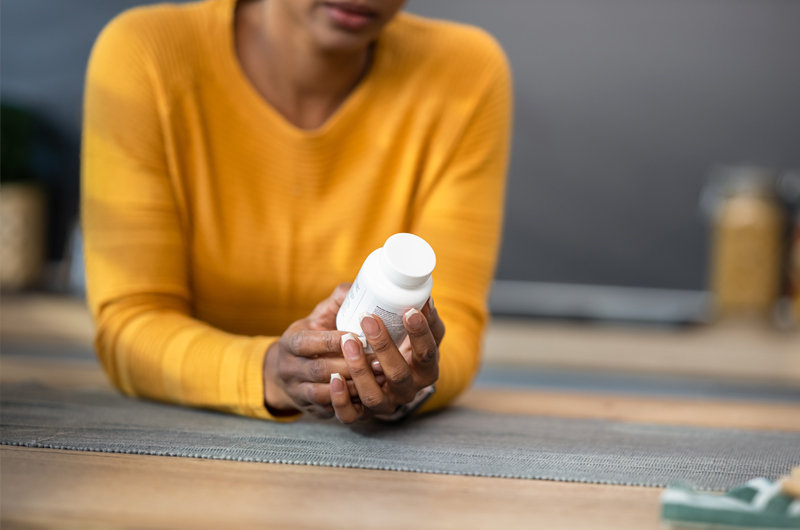 Woman holding bottle of zinc supplements
