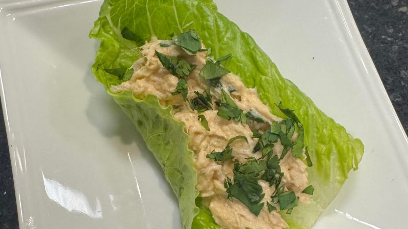 Image shows a close up of the bang bang chicken salad in a lettuce wrap on a plate.