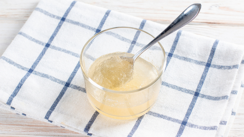 Top-down view of a glass with gelatin dissolved in water.