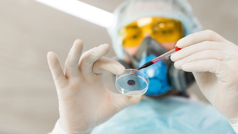 researcher in lab inspecting sample
