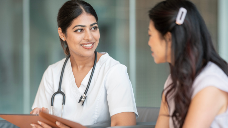 Healthcare professional having a friendly discussion with a patient, emphasizing trust, care, and support.