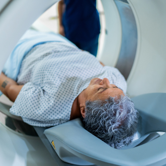Senior patient woman during magnetic resonance exam at hospital.