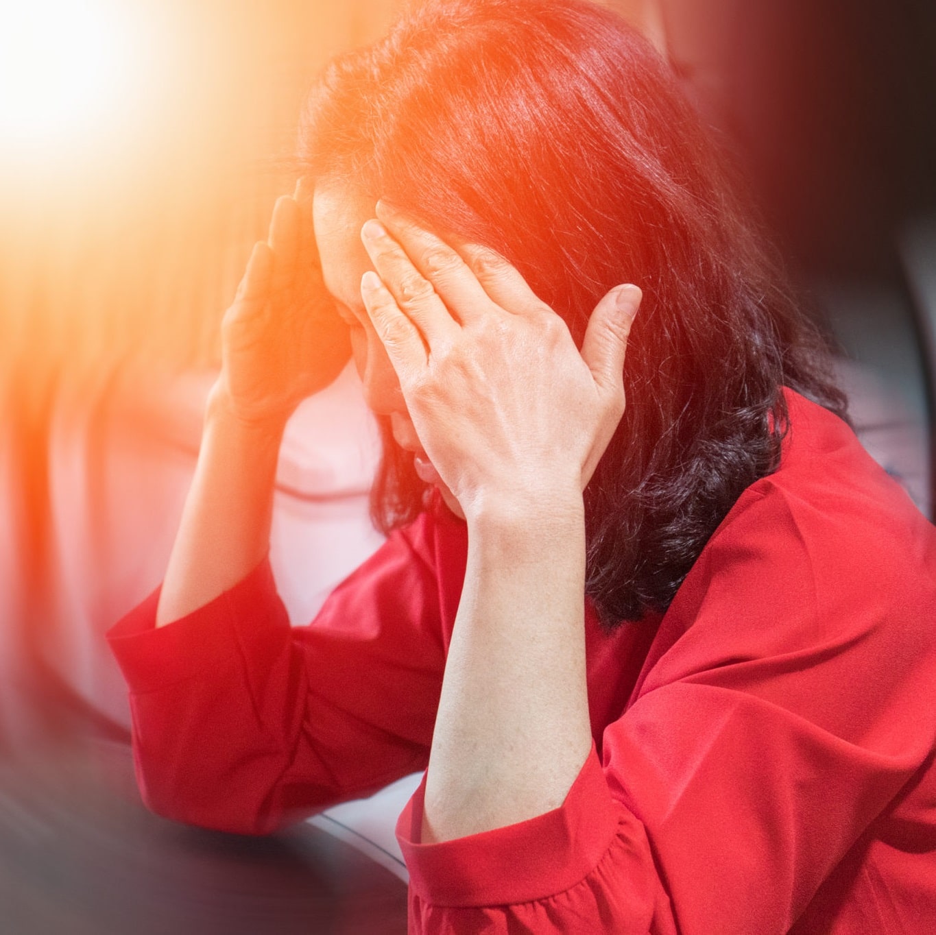 Woman with hands on temples