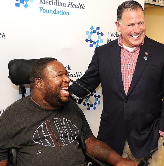 Former Rutgers football player Eric LeGrand is honored by his coach, Greg Schiano, with a generous gift to establish a new spinal cord treatment room.  