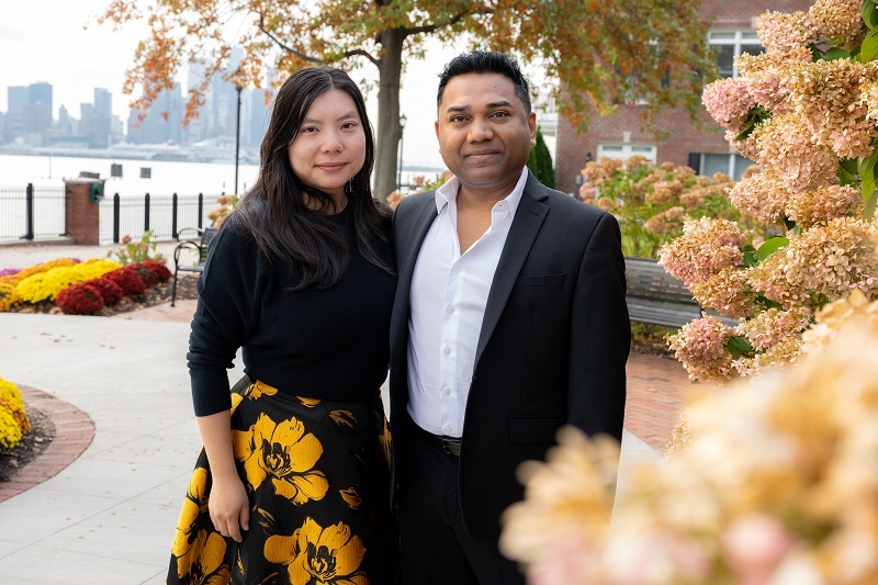 Ann Liu and Ashish Singh standing outside together smiling.