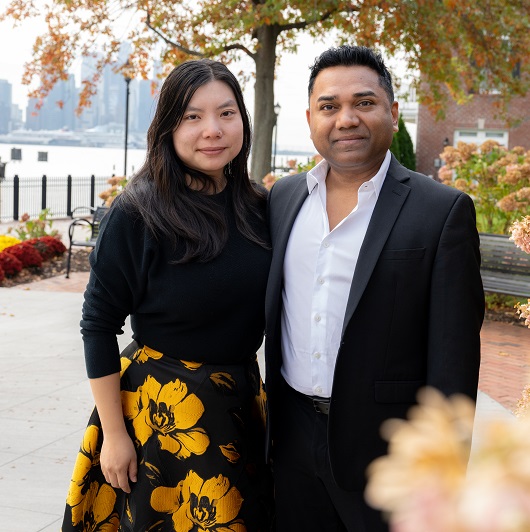 Ann Liu and Ashish Singh standing outside together smiling.