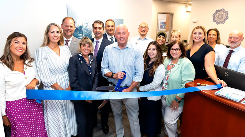 acupuncture team celebrating ribbon cutting