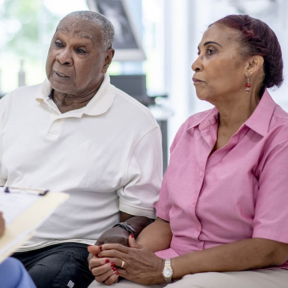 older man and woman holding hands