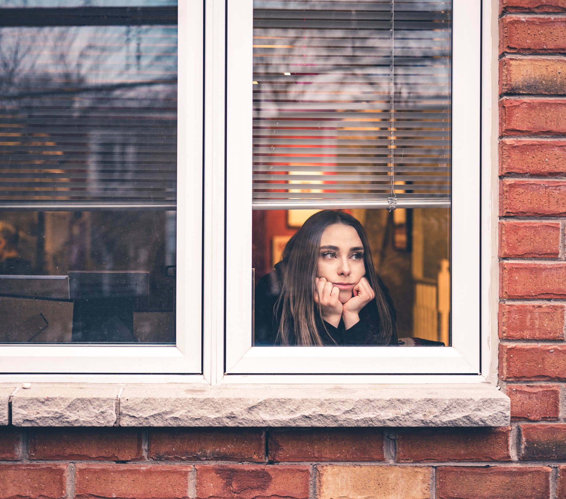 Woman looking out window