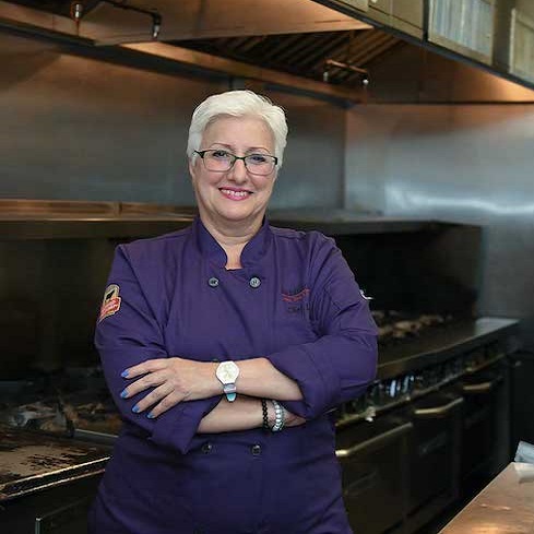 Lydia Liebchen standing in front of a stove