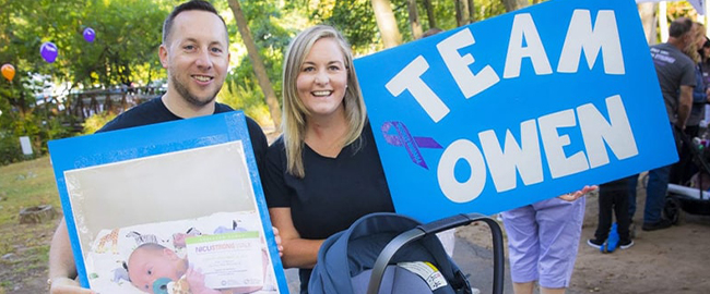 Sarah Garland and her husband holding a picture of their baby Owen