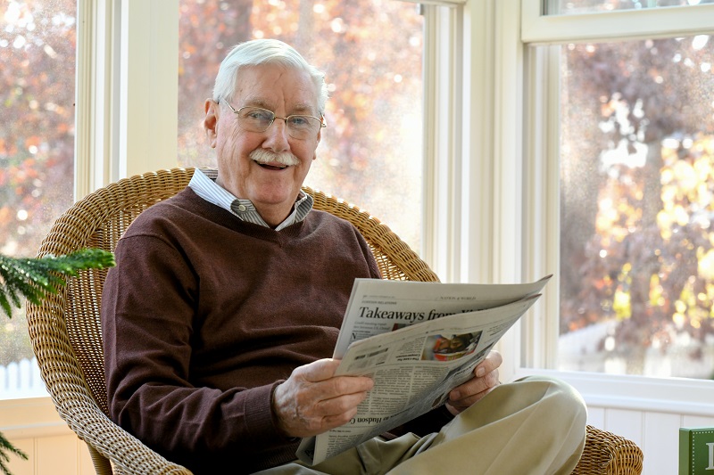 Jim Sandor reading the newspaper