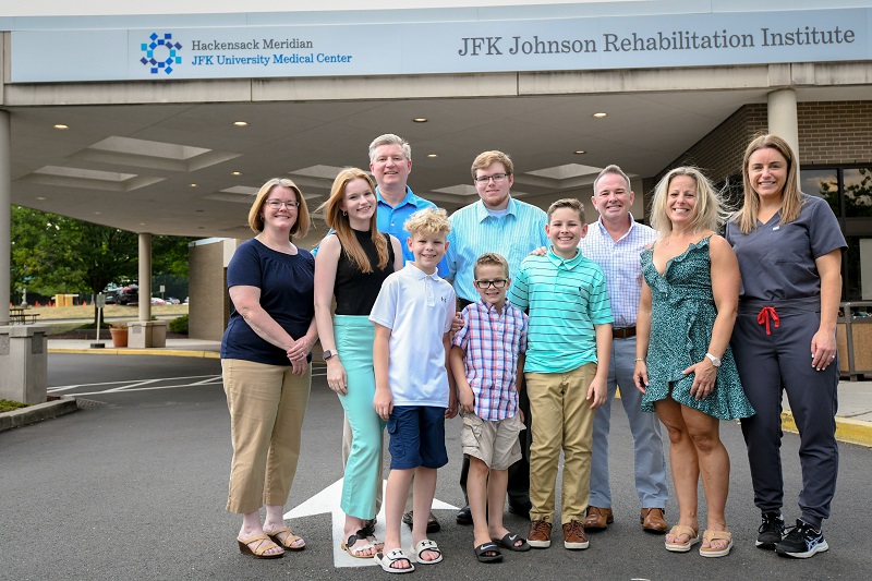 The Rydarowski family standing outside of JFK Johnson Rehabilitation Institute