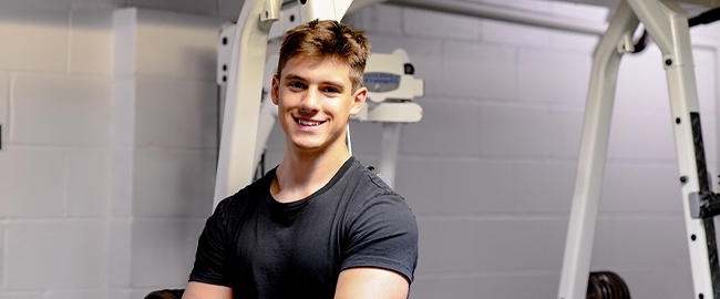 John Sherrod posing in a gym