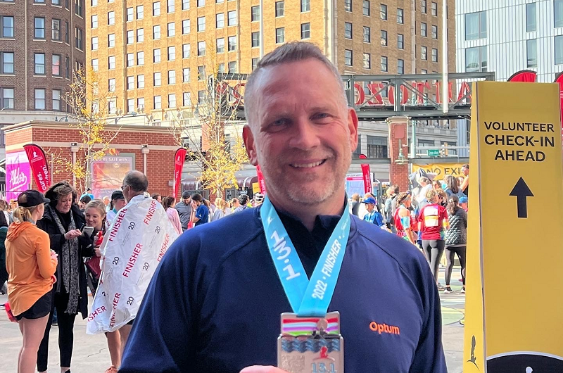 Gerald Branim smiling, with a medal around his neck, while at a race. 