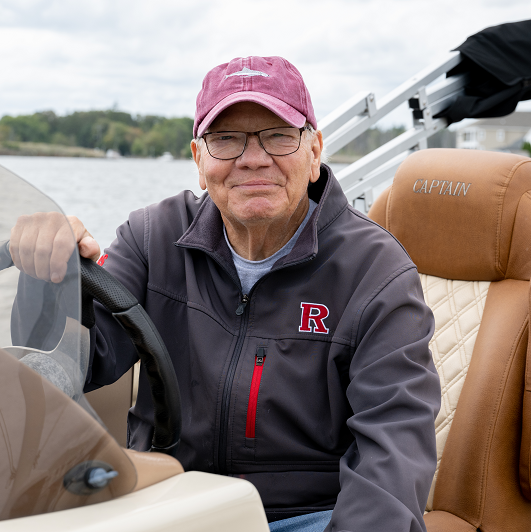 Ed Bechold on his boat smiling. 