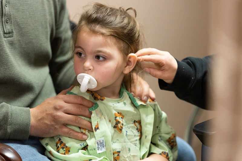 Giulia and her parents at the hospital, getting her cochlear implants turned on for the first time.