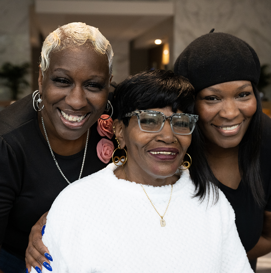 Diane Pratt and her family smiling together.