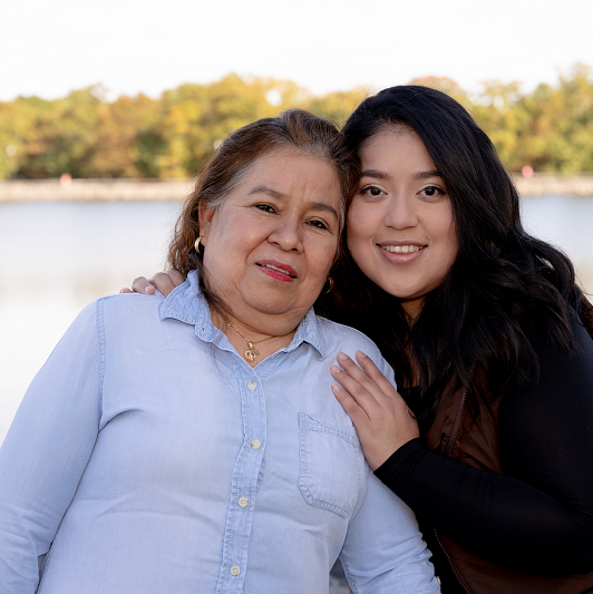 Esperanza and her daughter smiling and hugging.