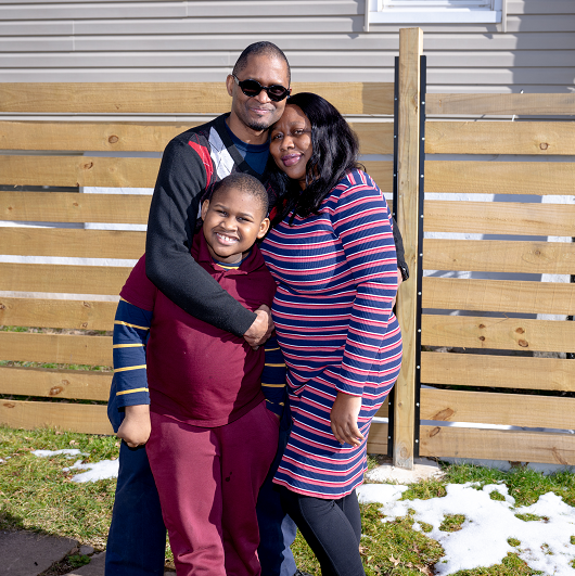 Glenn Williams smiling with his family.