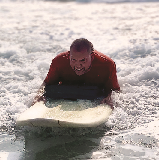 Mike O'Grady surfing at the beach.