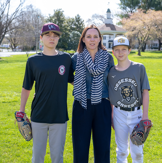 Jennifer Biedinger and her sons on a baseball field.